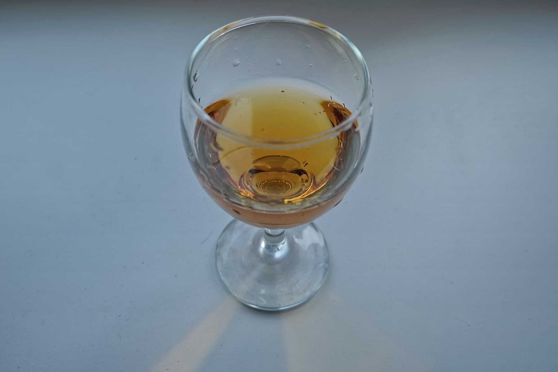 A glass of amber Georgian qvevri wine