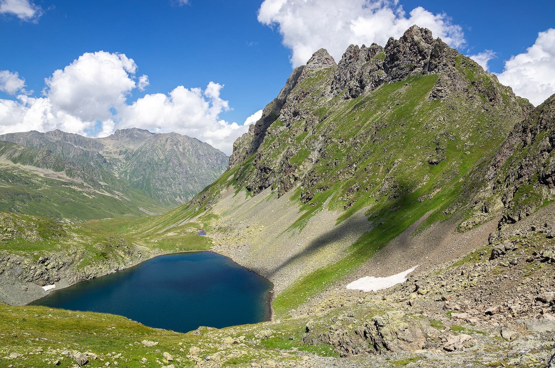 A glacial lake below the peaks of the Greater Caucasus